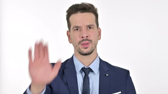 Portrait of Young Businessman Showing Stop Sign By Hand , White Background