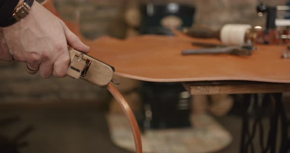 Craftsman Working with Leather in a Workshop