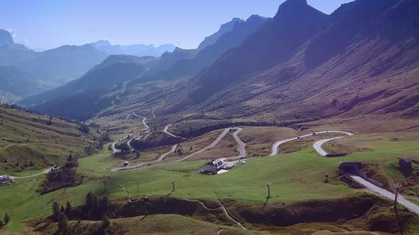 Breathtaking View of Dolomites Mountains Waving Road and Valley in Sun Light