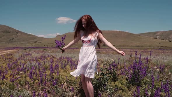 A Caucasian Beautiful Wonan Dancing on the Beautiful Field During Summer Day