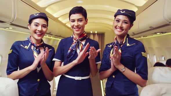 Cabin Crew Clapping Hands in Airplane