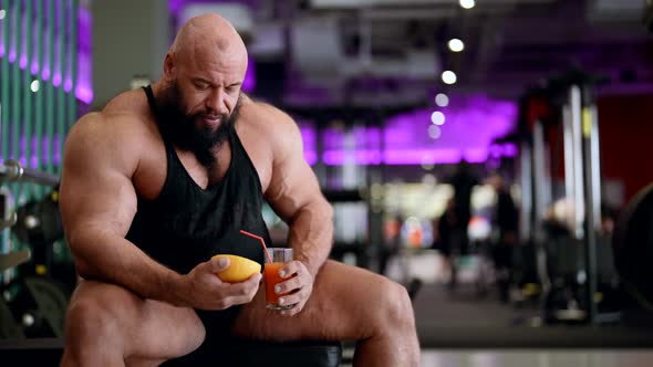 Jock is Drinking Fresh Juice in Gym Healthy Nutrition After Training Professional Bodybuilder