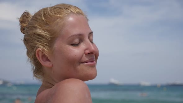 Pretty Caucasian blonde girl on the French coast  slow-mo 1920X1080 HD footage - Woman  enjoys sunba