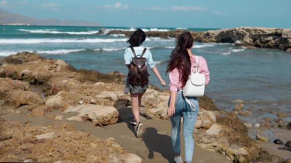 Happy Girls Making Selfie on a Cliff Over the Sea