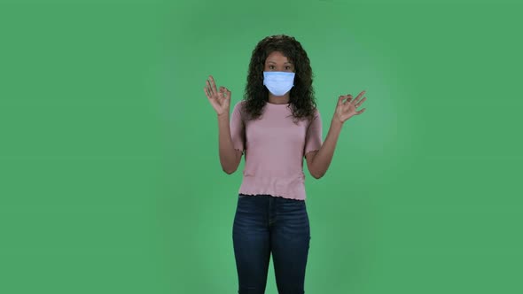 Portrait of Beautiful African American Young Woman in Medical Protective Face Mask Is Looking at