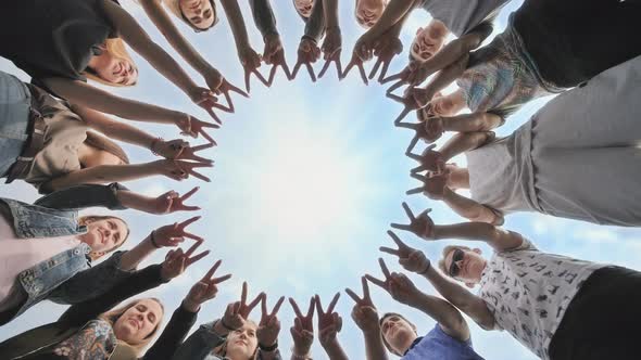 A Group of Friends Make a Circle Out of Their Fingers