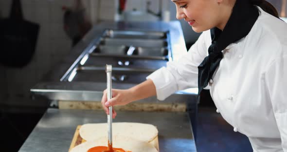 Chef applying sauce on flat bread