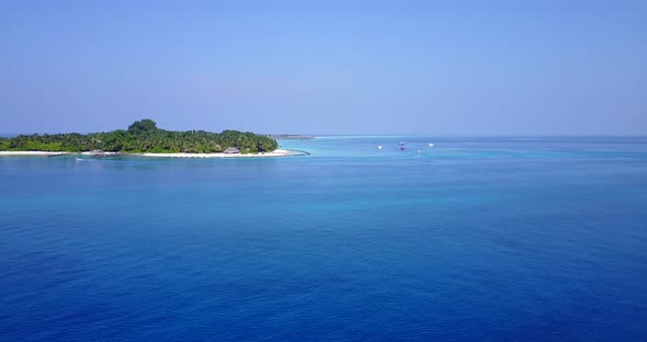 Wide drone travel shot of a paradise sunny white sand beach and aqua turquoise water background in 4