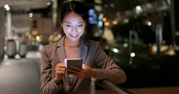 Woman looking at mobile phone in Hong Kong 