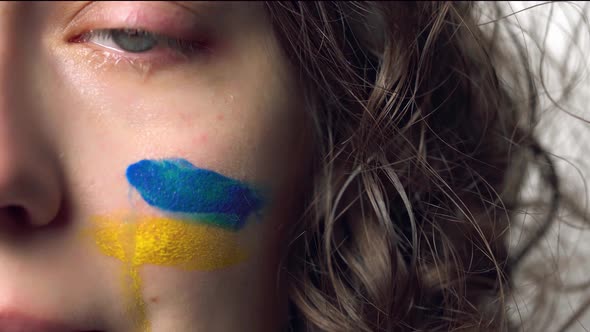 Tears Of Pain With Ukrainian Flag On Cheek. Crying Hopeful Sad Powerless Scared Emotional Woman