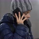 Confident Boy in Hat and Jacket Talking on Phone in Underground Covered Passage in City in Winter - VideoHive Item for Sale