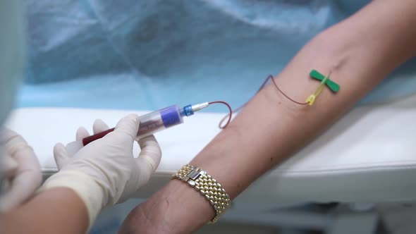 Female Doctor Take Blood Sample From Patient To Test for Coronavirus in Hospital. Sampling Plasma