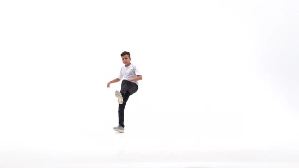 Little Boy Is Dancing a Modern Dance on the White Background in Black Leather Jackets and Jeans