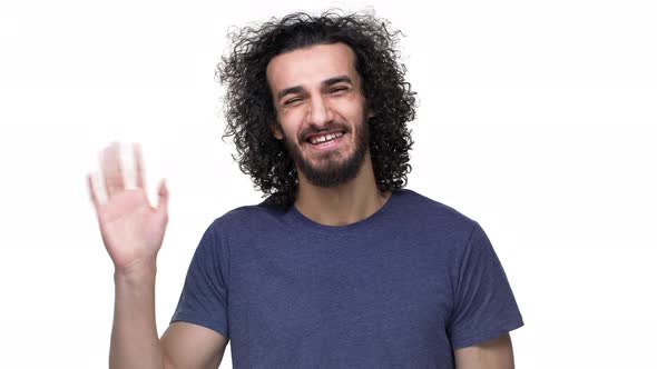 Portrait of Pleased Footballer with Curly Hair in Casual Dark Blue Tshirt Grinning and Welcoming