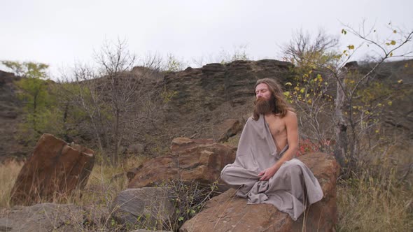 Yogi Sitting on the Rock in Meditation