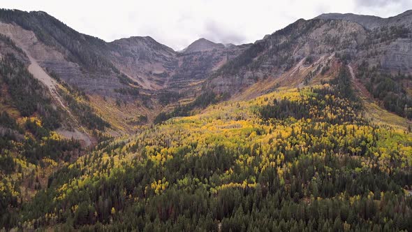 Aerial view flying towards mountain range during Fall