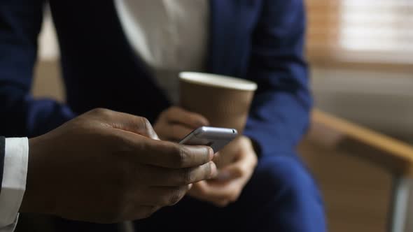 Close Up Hand of Dark-skinned Man Using Cellphone