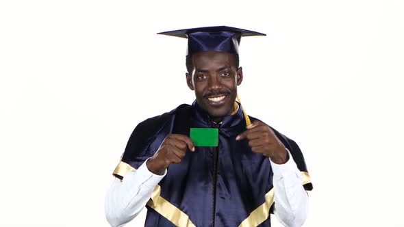 Graduate Holding a Green Card. White. Close Up