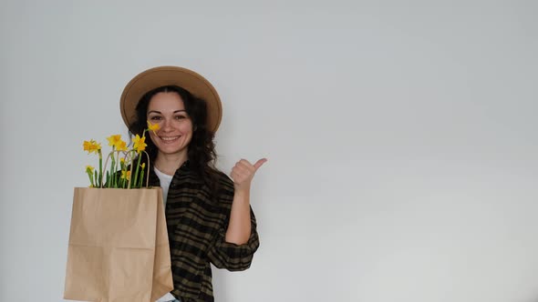 Female Florist in Shirt and Hat with Flower Paper Bag on White Background