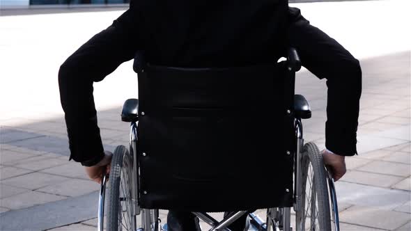 Cripple Man in Wheelchair Move Near Modern Business Centre