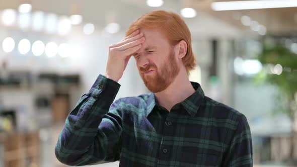 Portrait of Young Beard Redhead Man Having Headache