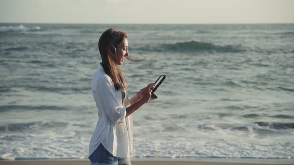 Woman with Tablet Standing by Ocean