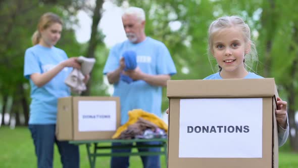 Smiling Girl Holding Donation Box