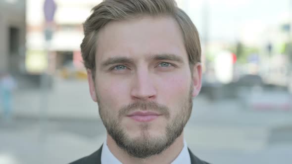 Close Up of Businessman Looking at the Camera Outdoor