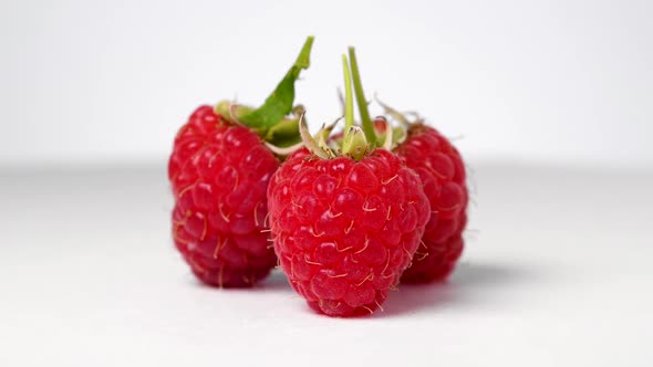 Ripe raspberry rotating on white background