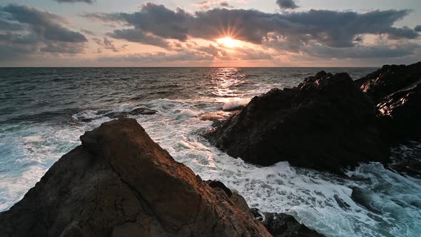 Morning sun at rocky sea coast