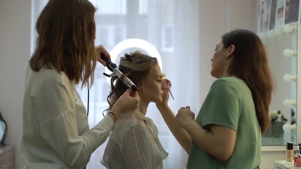 Close-up of young beautiful woman getting professional service in beauty salon.