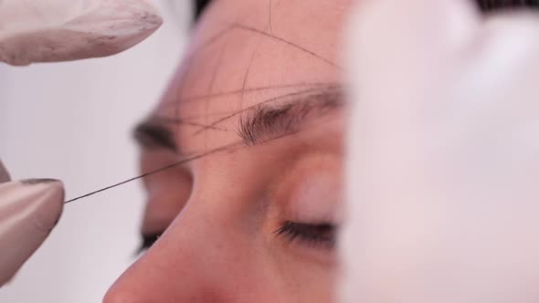 Closeup of Building a Universal Classic Sketch of Symmetrical Eyebrows Before the Procedure of