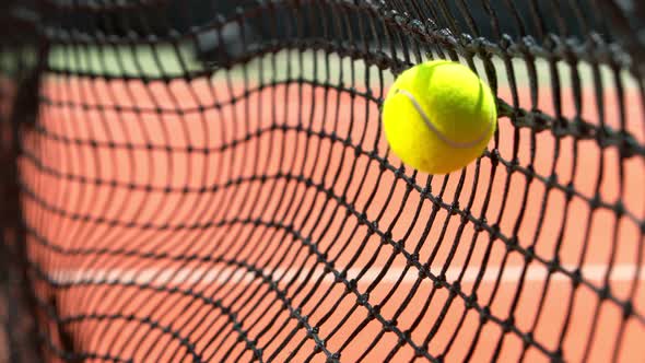 Super Slow Motion Shot of Tennis Ball Hitting the Net on Court at 1000Fps