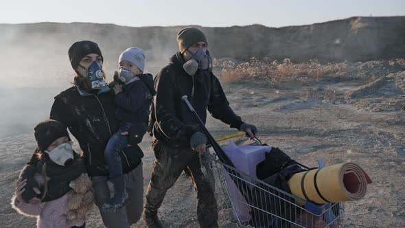 Survivor Family in Gas Mask Walking Through Clouds of Toxic Smoke and Burning in a Desert Landscape.