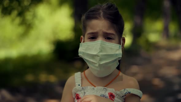 Children In Face Mask.Epidemic Coronavirus On Nature Outdoors. Kid Girl Walking In Protective Mask.