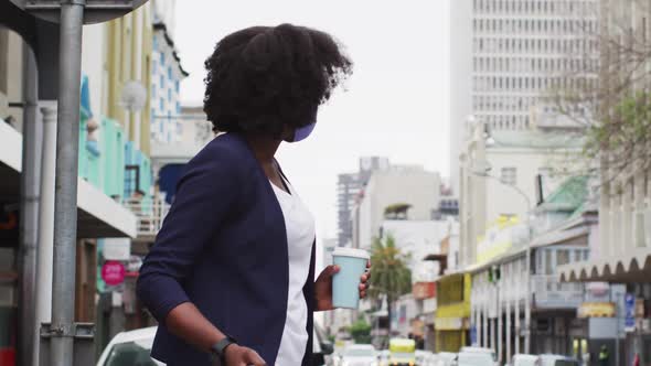 African american woman wearing face mask in street