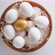 Close-up of a basket filled with chicken eggs. White and a golden one. - VideoHive Item for Sale
