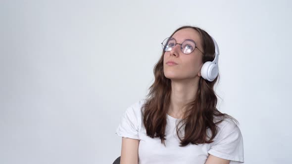 Nerd Girl Listens to Music on Headphones