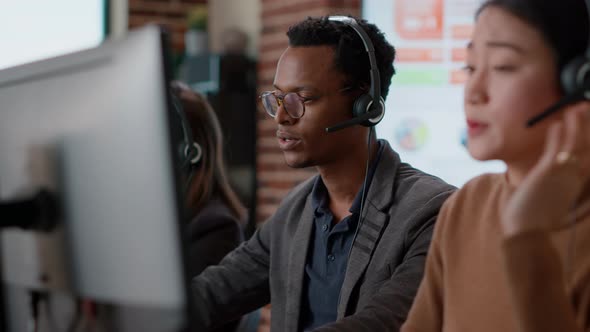 Male Call Center Operator Using Headset to Help People