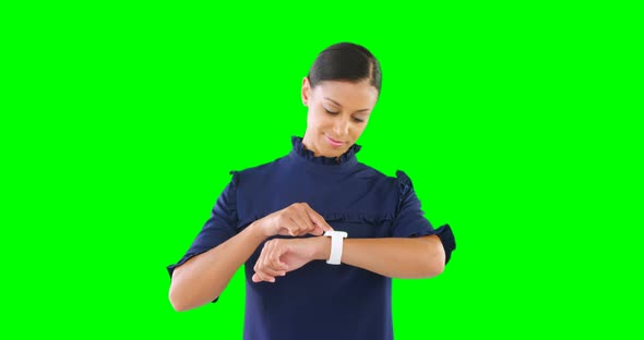 Woman using smartwatch against green screen 4k