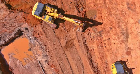 Digger on Earthworks in Excavator Dig the Trenche at Construction Site on Arial View of Earth Moving