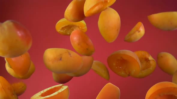 Juicy Apricot Halves Bounce on a Red Background