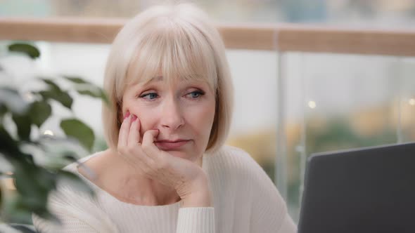 Closeup Mature Thoughtful Tired Sad Woman Looking at Laptop Screen Pensive Female Writer Journalist