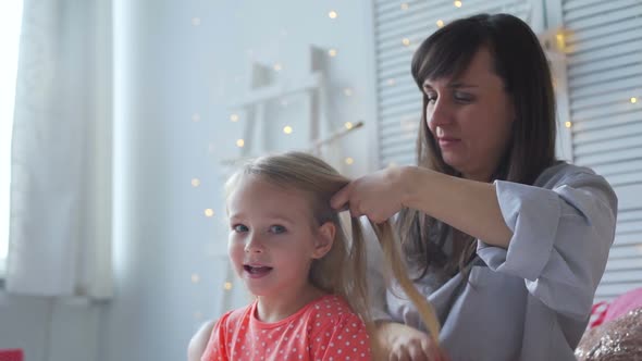 Mother and Daughter Talk While Brushing Hair