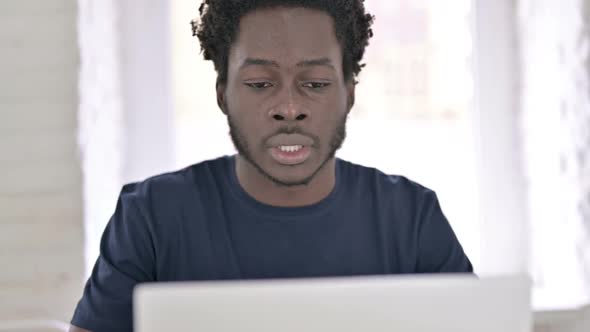 Close Up of African Man Coughing at Work