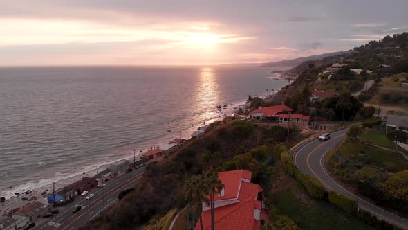 4k Aerial Mansion in Malibu on steep cliffs during sunset over pacific ocean