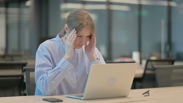 Young Woman Having Headache While Working on Laptop