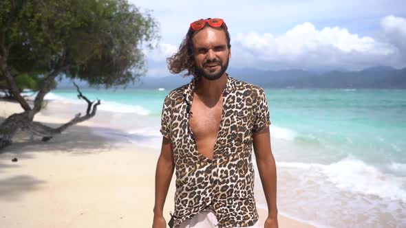 Confident Gorgeous Man Lifestyle Blogger Talking About Success to the Camera on Paradise Tropical