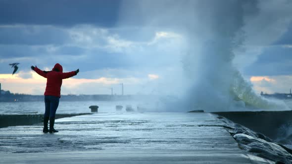 Woman Standing In Front Of The Storm Waves