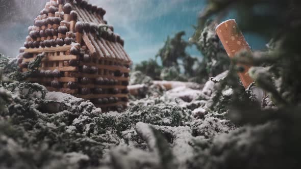 Stage with House Model of Matches Near Stubs at Snowfall